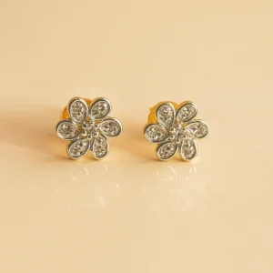 Delicate six petal floral stud earrings adorned with american diamond