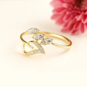 Graceful leaf and heart motif gold ring with shimmering stones